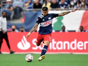 Jul 25, 2021; Foxborough, Massachusetts, USA; New England Revolution forward Gustavo Bou (7) shoots and scores against CF Montreal during the first half at Gillette Stadium. Mandatory Credit: Brian Fluharty-USA TODAY Sports