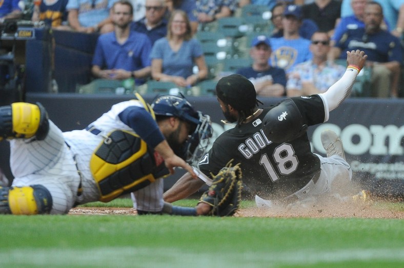 Jul 25, 2021; Milwaukee, Wisconsin, USA;  Chicago White Sox left fielder Brian Goodwin (18) slides safely into home against the Milwaukee Brewers in the second inning at American Family Field. Mandatory Credit: Michael McLoone-USA TODAY Sports