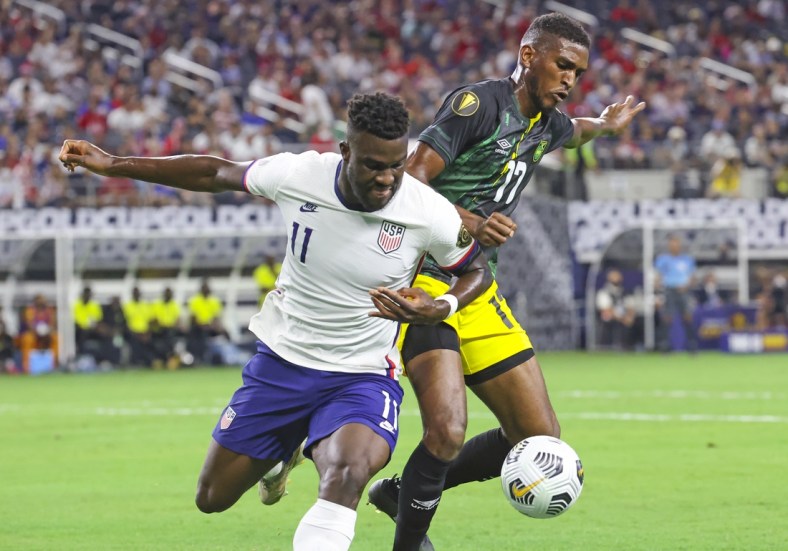 Jul 25, 2021; Arlington, Texas, USA; United States forward Daryl Dike (11) and Jamaica defender Damion Lowe (17)  battle for the ball during the first half of a CONCACAF Gold Cup quarterfinal soccer match at AT&T Stadium. Mandatory Credit: Kevin Jairaj-USA TODAY Sports