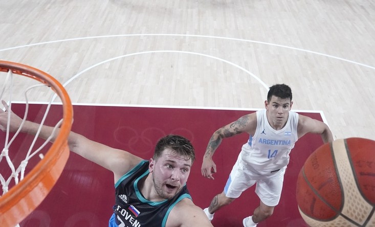 Jul 26, 2021; Saitama, Japan; Slovenia player Luka Doncic (77) and Argentina player Luca Vildoza (17) battle for a rebound during the Tokyo 2020 Olympic Summer Games at Saitama Super Arena. Mandatory Credit: Kyle Terada-USA TODAY Sports