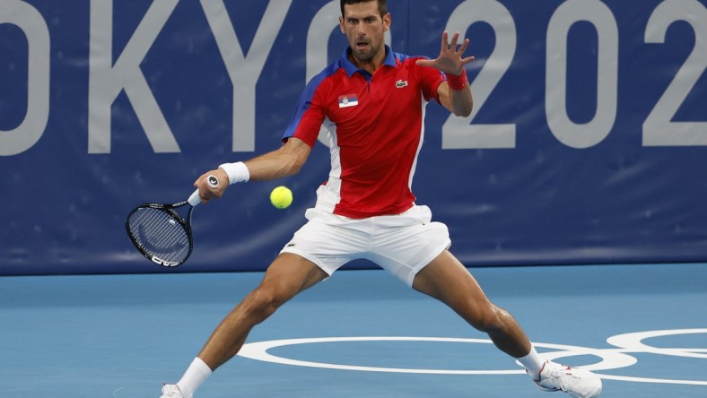 Jul 26, 2021; Tokyo, Japan; Novak Djokovic of Serbia hits a forehand against Jan-Lennard Struff of Germany (not pictured) in a second round mens' singles match during the Tokyo 2020 Olympic Summer Games at Ariake Tennis Park. Mandatory Credit: Geoff Burke-USA TODAY Sports