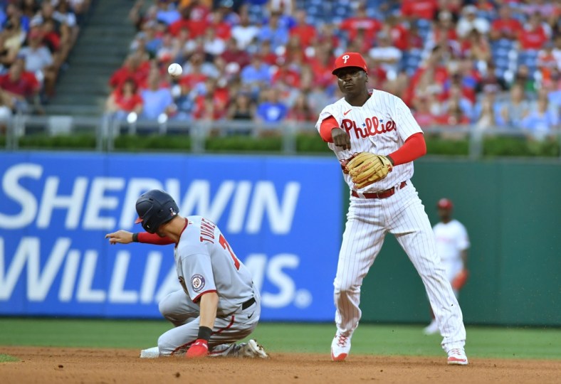 Jul 26, 2021; Philadelphia, Pennsylvania, USA; Philadelphia Phillies shortstop Didi Gregorius (18) throws to first base to complete a double play over Washington Nationals shortstop Trea Turner (7) during the fourth inning at Citizens Bank Park. Mandatory Credit: Eric Hartline-USA TODAY Sports
