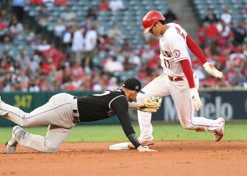 Jul 26, 2021; Anaheim, California, USA; Los Angeles Angels starting pitcher Shohei Ohtani (17) steals second against Colorado Rockies shortstop Trevor Story (27) during the first inning at Angel Stadium. Mandatory Credit: Richard Mackson-USA TODAY Sports