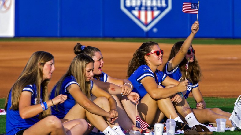 July 27, 2021; Oklahoma City, OK, USA; Members of the Finesse Fast Pitch team cheer on Team USA Softball as fans gather in the outfield of USA Softball Hall of Fame Stadium to watch the Olympic gold medal softball game between the United States and Japan on Tuesday, July 27, 2021, in Oklahoma City, Okla. Mandatory Credit: Chris Landsberger-USA TODAY NETWORK