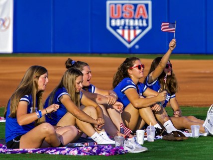 July 27, 2021; Oklahoma City, OK, USA; Members of the Finesse Fast Pitch team cheer on Team USA Softball as fans gather in the outfield of USA Softball Hall of Fame Stadium to watch the Olympic gold medal softball game between the United States and Japan on Tuesday, July 27, 2021, in Oklahoma City, Okla. Mandatory Credit: Chris Landsberger-USA TODAY NETWORK