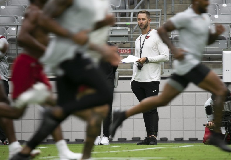Cardinals head coach Kliff Kingsbury watches players during a run test as Cardinals players report for camp at State Farm Stadium In Glendale on July 27, 2021.

Cardinals Report