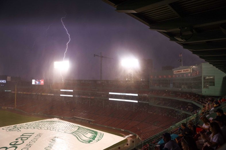 Jul 27, 2021; Boston, Massachusetts, USA; Lightning strikes outside Fenway Park during a rain delay between the Toronto Blue Jays and the Boston Red Sox. Mandatory Credit: Paul Rutherford-USA TODAY Sports
