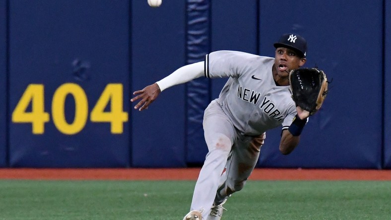 Jul 27, 2021; St. Petersburg, Florida, USA; New York Yankees center fielder Greg Allen (22) dives for a catch in the ninth inning against the Tampa Bay Rays at Tropicana Field. Mandatory Credit: Jonathan Dyer-USA TODAY Sports