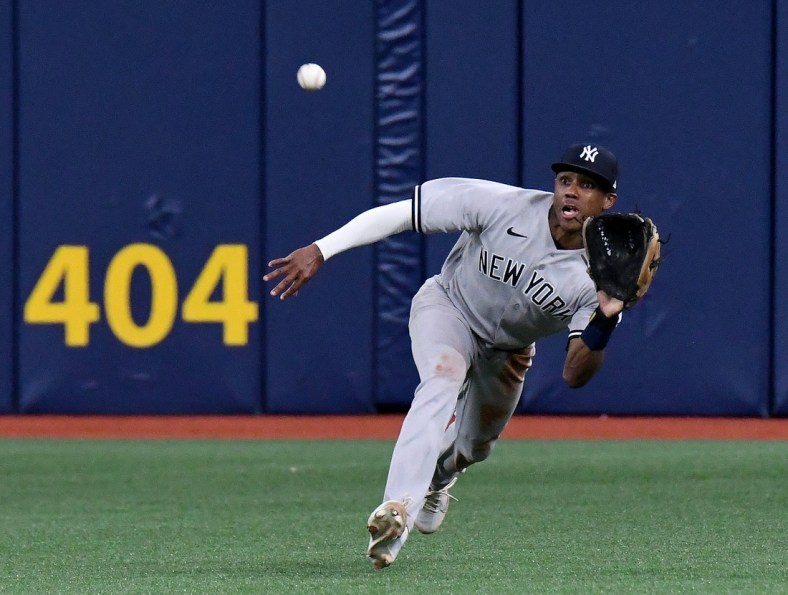 Jul 27, 2021; St. Petersburg, Florida, USA; New York Yankees center fielder Greg Allen (22) dives for a catch in the ninth inning against the Tampa Bay Rays at Tropicana Field. Mandatory Credit: Jonathan Dyer-USA TODAY Sports