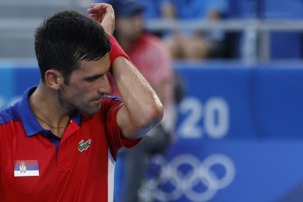 Jul 28, 2021; Tokyo, Japan; Novak Djokovic of Serbia wipes his face between points against Alejandro Davidovich Fokina of Spain (not pictured) in a mens' singles round of sixteen match during the Tokyo 2020 Olympic Summer Games at Ariake Tennis Park. Mandatory Credit: Geoff Burke-USA TODAY Sports