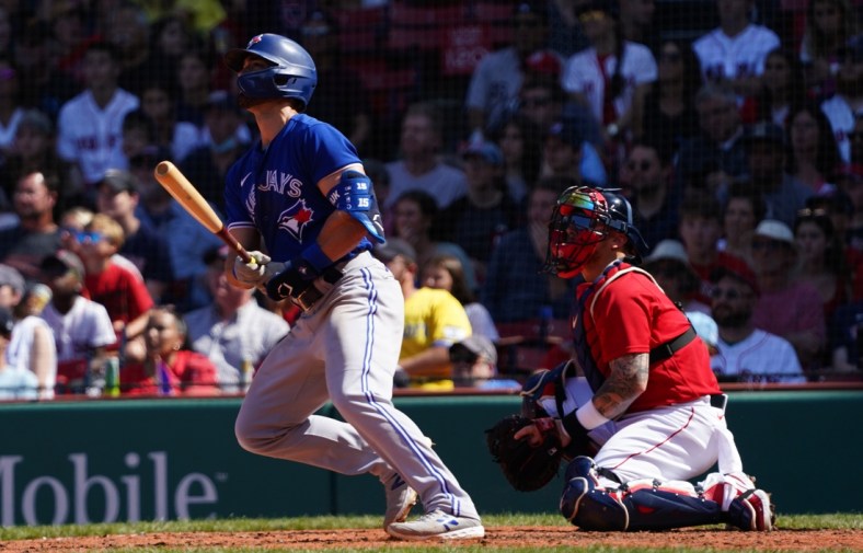 Jul 28, 2021; Boston, Massachusetts, USA; Toronto Blue Jays center fielder Randal Grichuk (15) hits a two run home run against the Boston Red Sox in the fourth inning at Fenway Park. Mandatory Credit: David Butler II-USA TODAY Sports