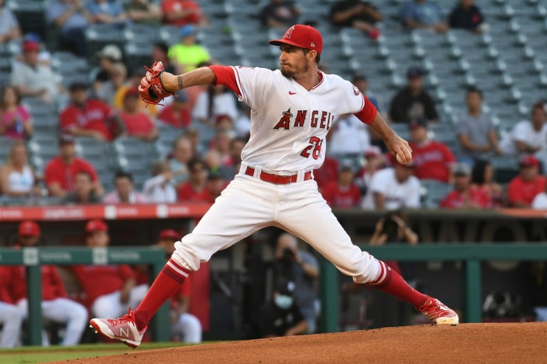 Jul 28, 2021; Anaheim, California, USA; Los Angeles Angels starting pitcher Andrew Heaney (28) throws against the Colorado Rockies during the first inning at Angel Stadium. Mandatory Credit: Richard Mackson-USA TODAY Sports