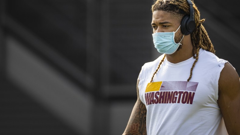 Jul 29, 2021; Richmond, VA, USA; Washington Football Team defensive end Chase Young (99) wears a face mask as he retrieves his jersey during training camp at Bon Secours Washington Redskins Training Cennter. Mandatory Credit: Scott Taetsch-USA TODAY Sports