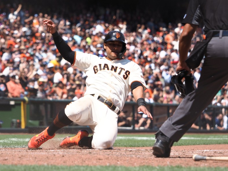 Jul 29, 2021; San Francisco, California, USA; San Francisco Giants second baseman Donovan Solano (7) scores a run against the Los Angeles Dodgers during the seventh inning at Oracle Park. Mandatory Credit: Kelley L Cox-USA TODAY Sports