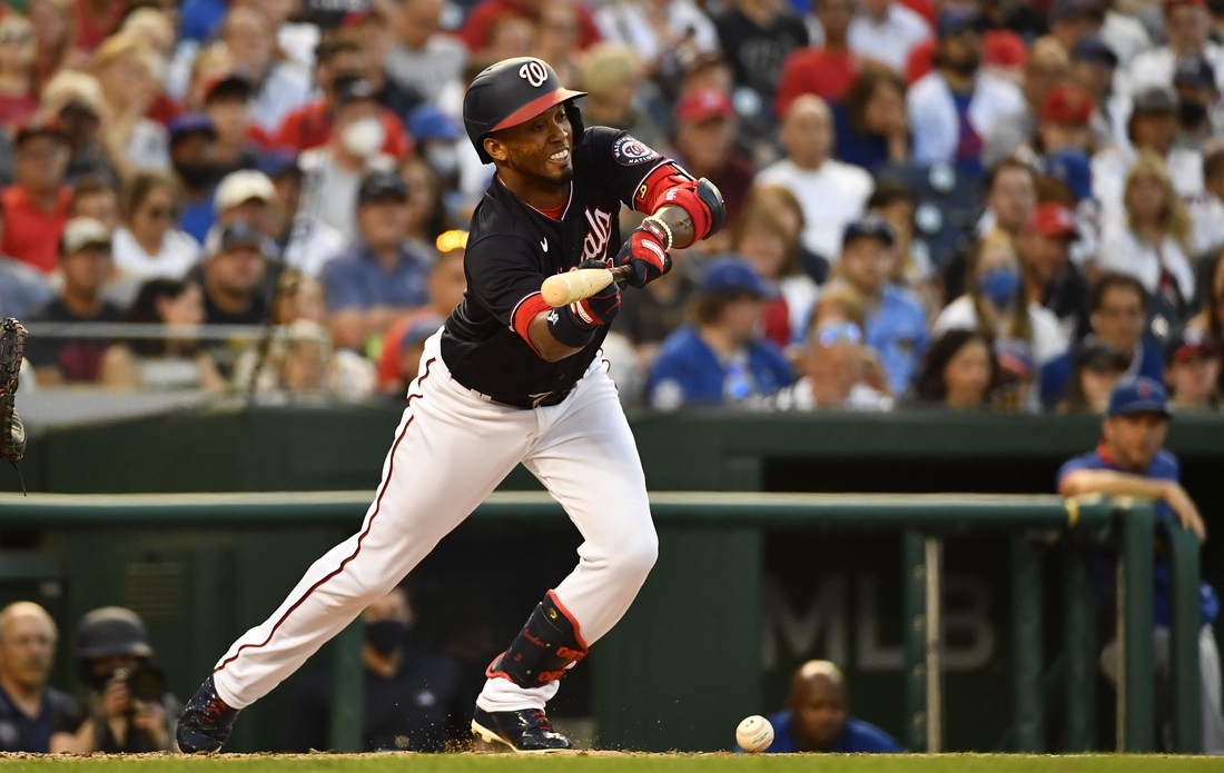 Jul 30, 2021; Washington, District of Columbia, USA; Washington Nationals shortstop Luis Garcia (2) hits a sacrifice bunt against the Chicago Cubs during the third inning at Nationals Park. Mandatory Credit: Brad Mills-USA TODAY Sports