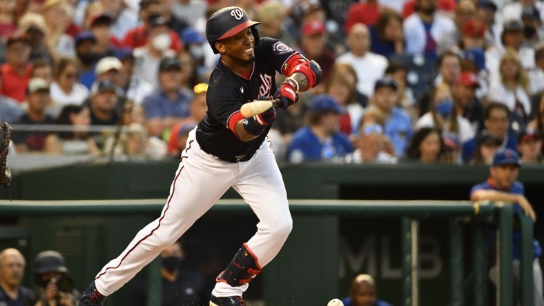 Jul 30, 2021; Washington, District of Columbia, USA; Washington Nationals shortstop Luis Garcia (2) hits a sacrifice bunt against the Chicago Cubs during the third inning at Nationals Park. Mandatory Credit: Brad Mills-USA TODAY Sports