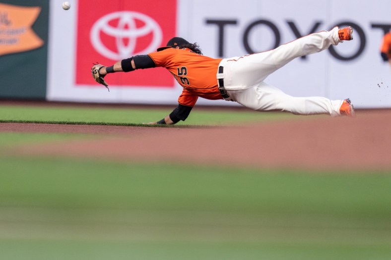 Jul 30, 2021; San Francisco, California, USA;  San Francisco Giants shortstop Brandon Crawford (35) dives but cannot catch the baseball during the first inning against the Houston Astros at Oracle Park. Mandatory Credit: Neville E. Guard-USA TODAY Sports