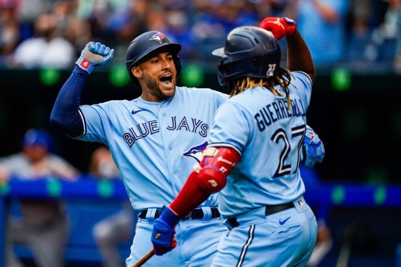 Jul 31, 2021; Toronto, Ontario, CAN; Toronto Blue Jays center fielder George Springer (4) celebrates with designated hitter Vladimir Guerrero Jr. (27) after hitting a home run against the Kansas City Royals during the first inning at Rogers Centre. Mandatory Credit: Kevin Sousa-USA TODAY Sports