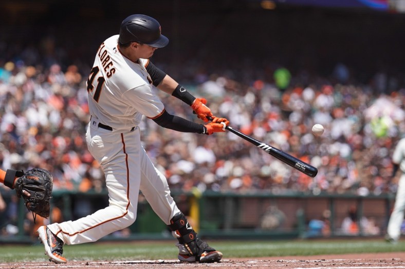 Jul 31, 2021; San Francisco, California, USA; San Francisco Giants second baseman Wilmer Flores (41) hits a RBI home run during the third inning against the Houston Astros at Oracle Park. Mandatory Credit: Stan Szeto-USA TODAY Sports