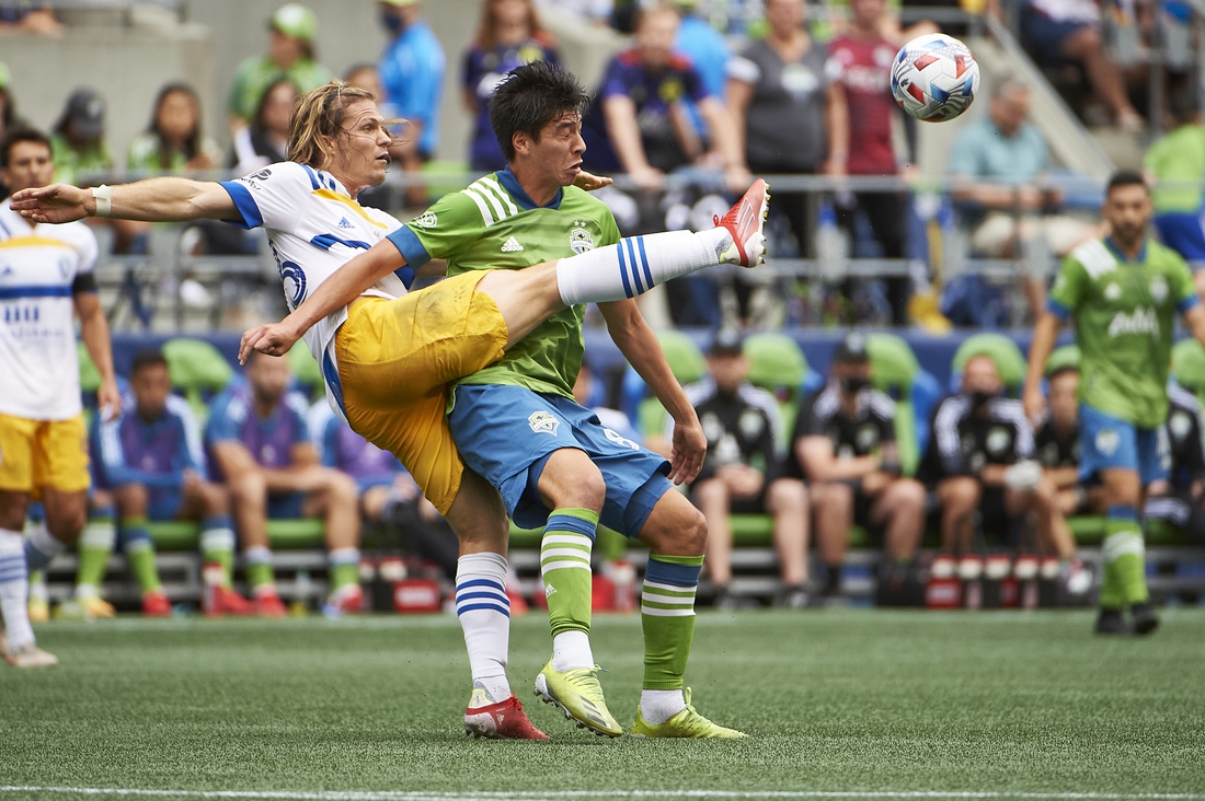 Jul 31, 2021; Seattle, Washington, USA; San Jose Earthquakes midfielder Florian Jungwirth (23) passes the ball against Seattle Sounders midfielder Josh Atencio (84) during the first half at CenturyLink Field. Mandatory Credit: Troy Wayrynen-USA TODAY Sports