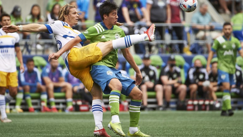 Jul 31, 2021; Seattle, Washington, USA; San Jose Earthquakes midfielder Florian Jungwirth (23) passes the ball against Seattle Sounders midfielder Josh Atencio (84) during the first half at CenturyLink Field. Mandatory Credit: Troy Wayrynen-USA TODAY Sports