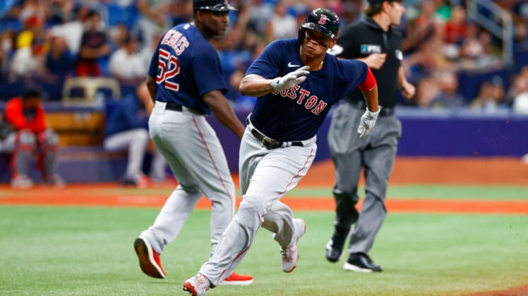 Jul 31, 2021; St. Petersburg, Florida, USA; Boston Red Sox third baseman Rafael Devers (11) scores a run in the first inning against the Tampa Bay Rays at Tropicana Field. Mandatory Credit: Nathan Ray Seebeck-USA TODAY Sports