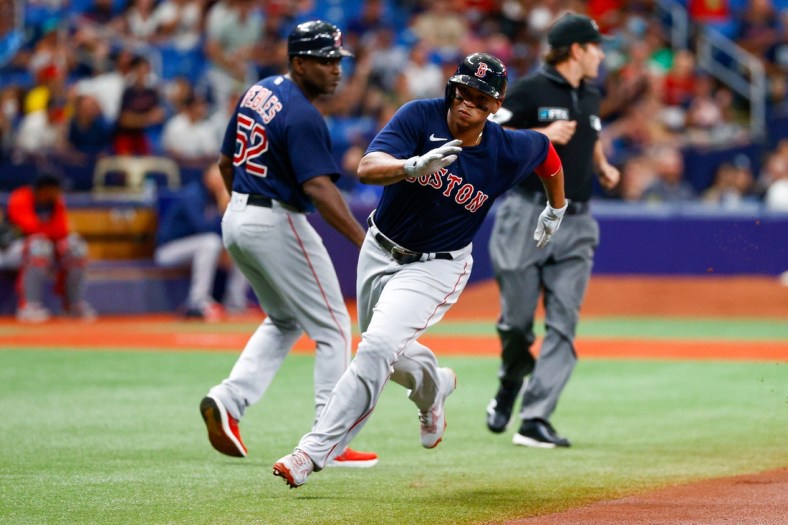 Jul 31, 2021; St. Petersburg, Florida, USA; Boston Red Sox third baseman Rafael Devers (11) scores a run in the first inning against the Tampa Bay Rays at Tropicana Field. Mandatory Credit: Nathan Ray Seebeck-USA TODAY Sports