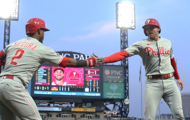 Jul 31, 2021; Pittsburgh, Pennsylvania, USA; Philadelphia Phillies second baseman Jean Segura (2) congratulates first baseman Brad Miller (13) after Miller scored a run against the Pittsburgh Pirates during the fifth inning at PNC Park. Mandatory Credit: Charles LeClaire-USA TODAY Sports