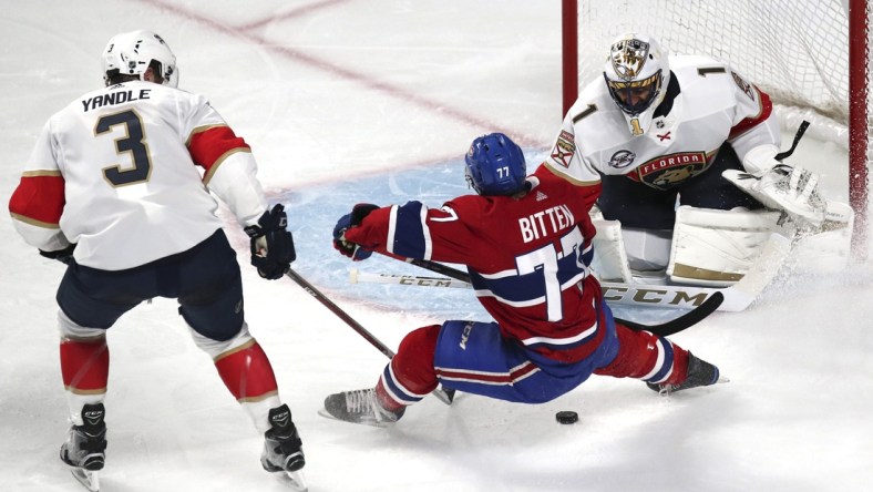 Sep 19, 2018; Montreal, Quebec, CAN; Montreal Canadiens Will Bitten (77) attempts a shot on Florida Panthers goaltender Roberto Luongo (1) as defenseman Keith Yandle (3) defends during the second period at Bell Centre. Mandatory Credit: Jean-Yves Ahern-USA TODAY Sports