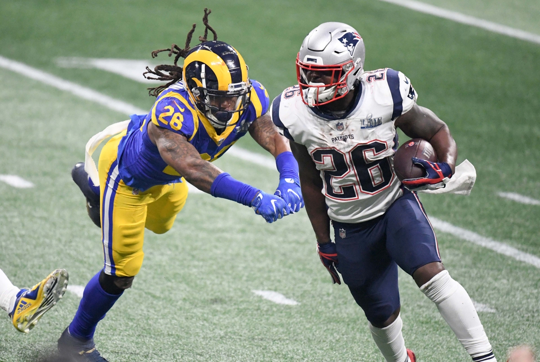 Feb 3, 2019; Atlanta, GA, USA; New England Patriots running back Sony Michel (right) is defended by Los Angeles Rams inside linebacker Mark Barron (left) in Super Bowl LIII at Mercedes-Benz Stadium. The Patriots defeated the Rams 13-3 to win an NFL record-tying sixth championship. Mandatory Credit: Kirby Lee-USA TODAY Sports