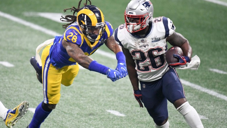 Feb 3, 2019; Atlanta, GA, USA; New England Patriots running back Sony Michel (right) is defended by Los Angeles Rams inside linebacker Mark Barron (left) in Super Bowl LIII at Mercedes-Benz Stadium. The Patriots defeated the Rams 13-3 to win an NFL record-tying sixth championship. Mandatory Credit: Kirby Lee-USA TODAY Sports