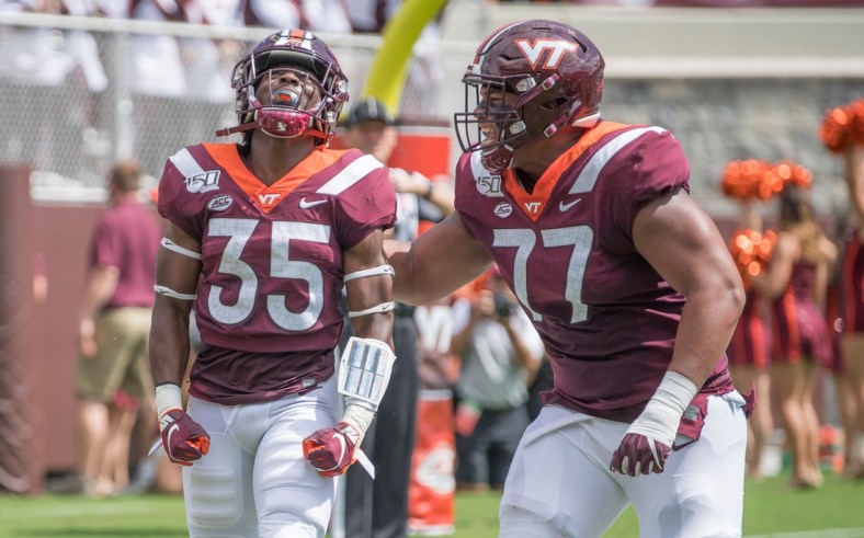 Sep 7, 2019; Blacksburg, VA, USA; Virginia Tech Hokies running back Keshawn King (35) celebrates his first touch down with Christian Darrisaw (77) in the first period against the Old Dominion Monarchs at Lane Stadium. Mandatory Credit: Lee Luther Jr.-USA TODAY Sports