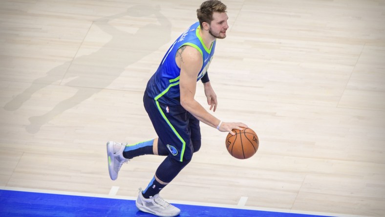 Jan 8, 2020; Dallas, Texas, USA; Dallas Mavericks forward Luka Doncic (77) and the shadow outline of former player Dirk Nowitzki during the game between the Mavericks and the Nuggets at the American Airlines Center. Mandatory Credit: Jerome Miron-USA TODAY Sports