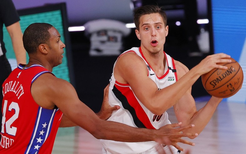 Aug 9, 2020; Lake Buena Vista, Florida, USA;  Zach Collins #33 of the Portland Trail Blazers looks to pass against Al Horford #42 of the Philadelphia 76ers at Visa Athletic Center at ESPN Wide World Of Sports Complex on August 09, 2020 in Lake Buena Vista, Florida.  Mandatory Credit: Kevin C. Cox/Pool Photo-USA TODAY Sports