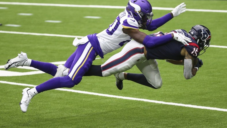 Oct 4, 2020; Houston, Texas, USA; Houston Texans wide receiver Will Fuller (15) makes a reception against Minnesota Vikings cornerback Jeff Gladney (20) during the third quarter at NRG Stadium. Mandatory Credit: Troy Taormina-USA TODAY Sports