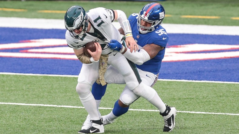 Nov 15, 2020; East Rutherford, New Jersey, USA; Philadelphia Eagles quarterback Carson Wentz (11) is sacked by New York Giants defensive tackle B.J. Hill (95) during the first half at MetLife Stadium. Mandatory Credit: Vincent Carchietta-USA TODAY Sports