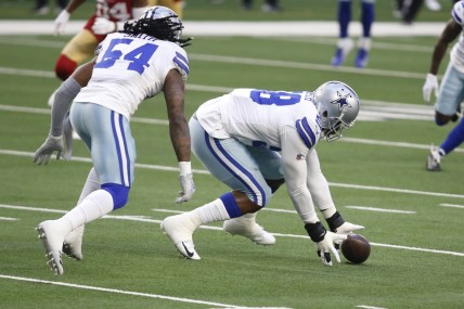 Dec 20, 2020; Arlington, Texas, USA; Dallas Cowboys defensive end Aldon Smith (58) picks up a fumble against the San Francisco 49ers in the first quarter at AT&T Stadium. Mandatory Credit: Tim Heitman-USA TODAY Sports