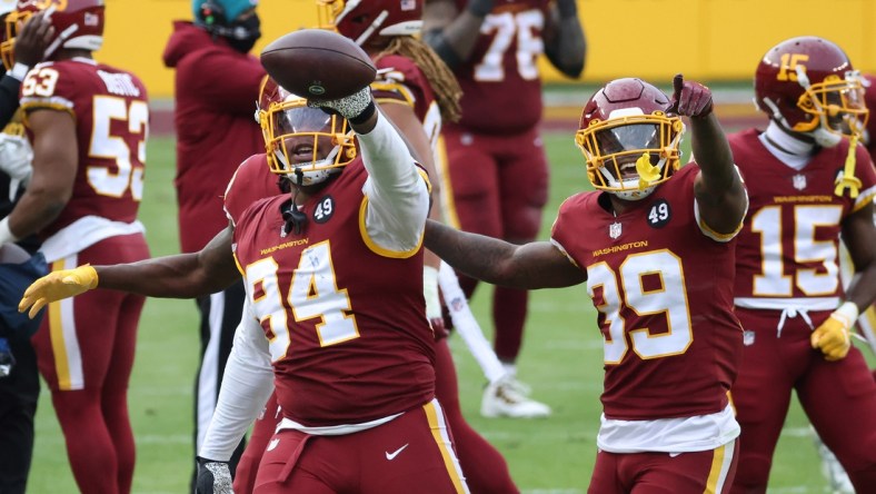 Dec 20, 2020; Landover, Maryland, USA; Washington Football Team nose tackle Daron Payne (94) celebrates with teammates after intercepting a pass against the Seattle Seahawks in the fourth quarter at FedExField. Mandatory Credit: Geoff Burke-USA TODAY Sports