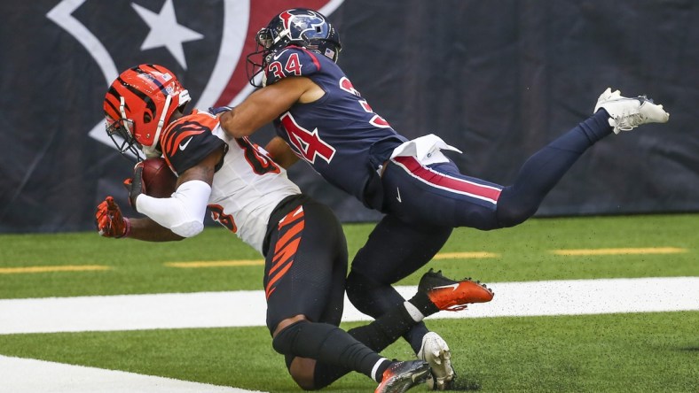 Dec 27, 2020; Houston, Texas, USA; Cincinnati Bengals wide receiver Tee Higgins (85) makes a reception for a touchdown against Houston Texans cornerback John Reid (34) during the third quarter at NRG Stadium. Mandatory Credit: Troy Taormina-USA TODAY Sports