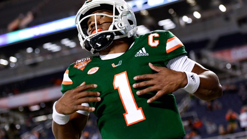 Dec 29, 2020; Orlando, FL, USA; Miami Hurricanes quarterback D'Eriq King (1) reacts after running the ball in for a touchdown which is called back for a penalty during the first half against the Oklahoma State Cowboys during the Cheez-It Bowl Game at Camping World Stadium. Mandatory Credit: Douglas DeFelice-USA TODAY Sports