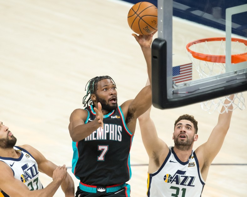 Mar 26, 2021; Salt Lake City, Utah, USA; Memphis Grizzlies forward Justise Winslow (7) shoots the ball against Utah Jazz forward Georges Niang (31) during the first half at Vivint Smart Home Arena. Mandatory Credit: Russell Isabella-USA TODAY Sports