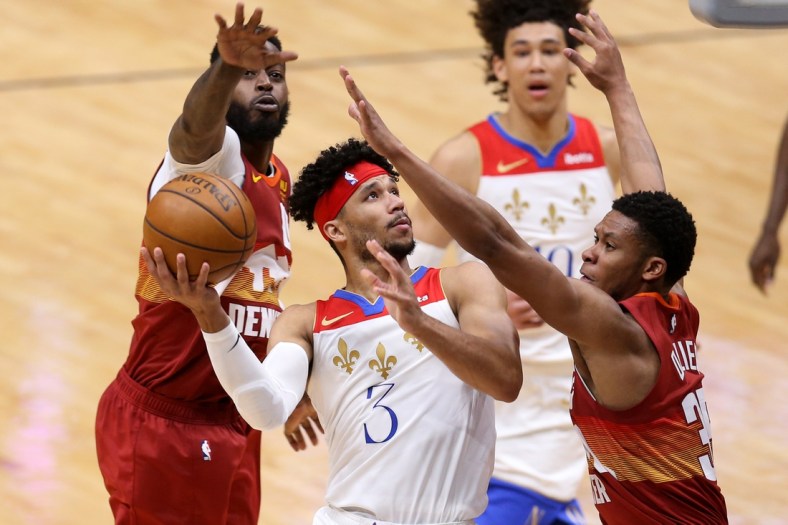 Mar 26, 2021; New Orleans, Louisiana, USA; New Orleans Pelicans guard Josh Hart (3) goes up for a shot while defended by Denver Nuggets forward JaMychal Green (0) and guard PJ Dozier (35) in the fourth quarter at the Smoothie King Center. Mandatory Credit: Chuck Cook-USA TODAY Sports