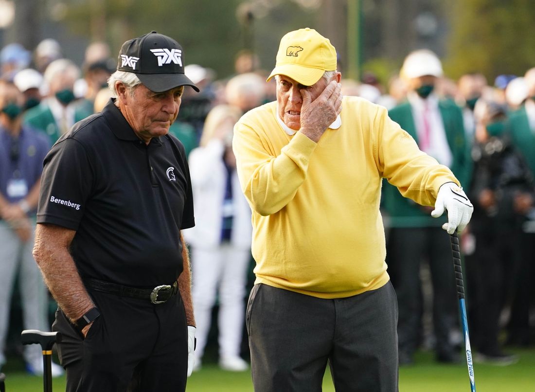 Apr 8, 2021; Augusta, Georgia, USA; Jack Nicklaus wipes a tear as Gary Player looks on at the first tee during the first round of The Masters golf tournament. Mandatory Credit: Rob Schumacher-USA TODAY Sports