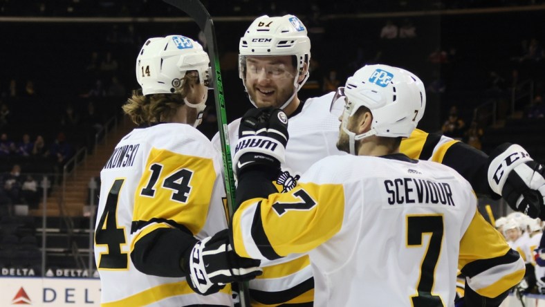 Apr 8, 2021; New York, New York, USA; Pittsburgh Penguins left wing Radim Zohorna (67) celebrates with center Mark Jankowski (14) and center Colton Sceviour (7) his goal scored against the New York Rangers during the first period at Madison Square Garden. Mandatory Credit:  Bruce Bennett/Pool Photo-USA TODAY Sports