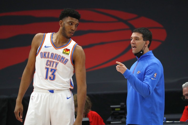Apr 18, 2021; Tampa, Florida, USA; Oklahoma City Thunder head coach Mark Daigneault talks with center Tony Bradley (13) against the Toronto Raptors during the first half at Amalie Arena. Mandatory Credit: Kim Klement-USA TODAY Sports