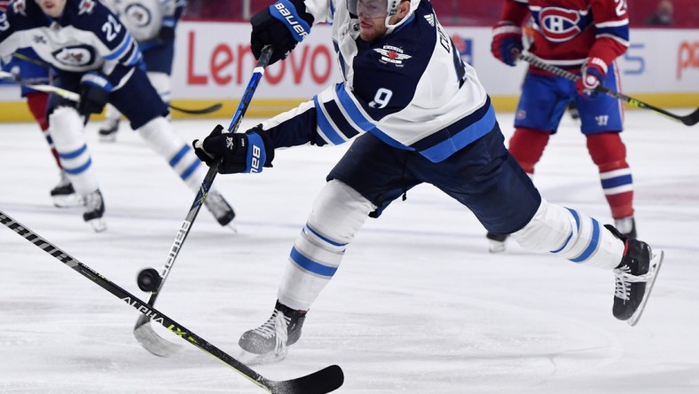 Apr 30, 2021; Montreal, Quebec, CAN; Winnipeg Jets forward Andrew Copp (9) shoots the puck towards the net during the first period of the game against the Montreal Canadiens at the Bell Centre. Mandatory Credit: Eric Bolte-USA TODAY Sports