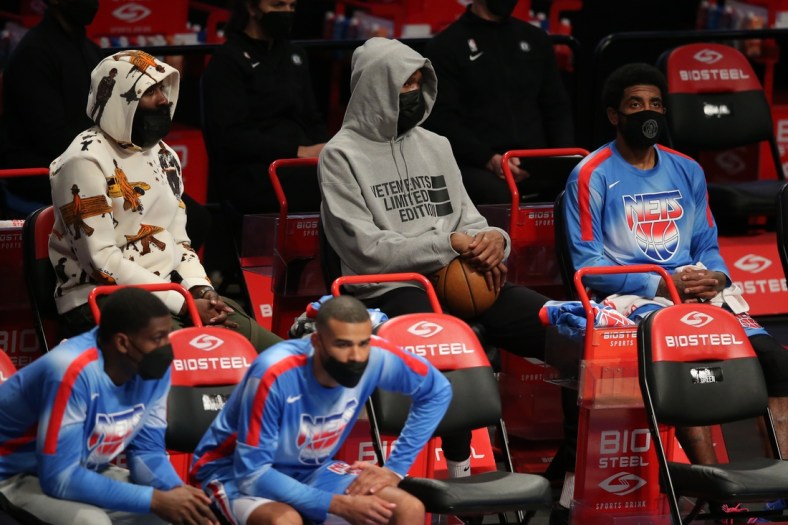 Apr 30, 2021; Brooklyn, New York, USA; Brooklyn Nets shooting guard James Harden (left to right) and power forward Kevin Durant (7) and point guard Kyrie Irving (11) sit on the bench during the third quarter against the Portland Trailblazers at Barclays Center. Harden and Durant didn't play in the game. Mandatory Credit: Brad Penner-USA TODAY Sports