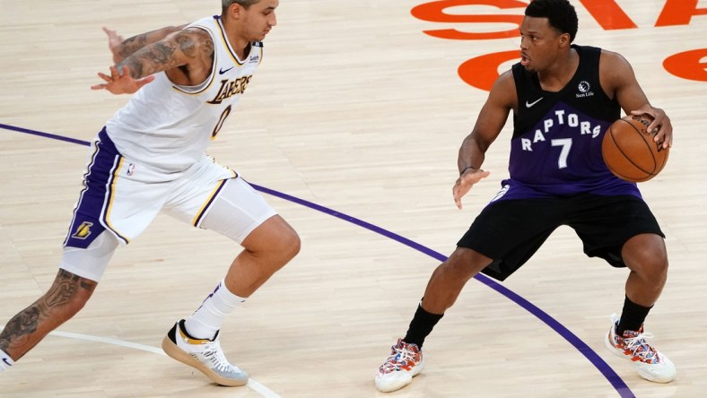 May 2, 2021; Los Angeles, California, USA; Toronto Raptors guard Kyle Lowry (7) controls the ball against Los Angeles Lakers forward Kyle Kuzma (0) during the second half at Staples Center. Mandatory Credit: Gary A. Vasquez-USA TODAY Sports