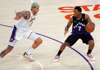 May 2, 2021; Los Angeles, California, USA; Toronto Raptors guard Kyle Lowry (7) controls the ball against Los Angeles Lakers forward Kyle Kuzma (0) during the second half at Staples Center. Mandatory Credit: Gary A. Vasquez-USA TODAY Sports