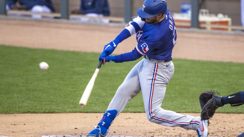 May 4, 2021; Minneapolis, Minnesota, USA; Texas Rangers right fielder David Dahl (21) hits a ground rule double in the second inning against the Minnesota Twins at Target Field. Mandatory Credit: Jesse Johnson-USA TODAY Sports